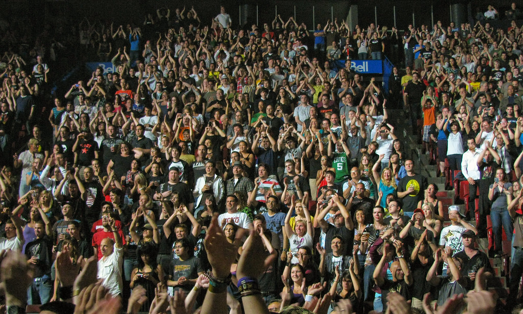Crowd with raised hands during a packed live music performance