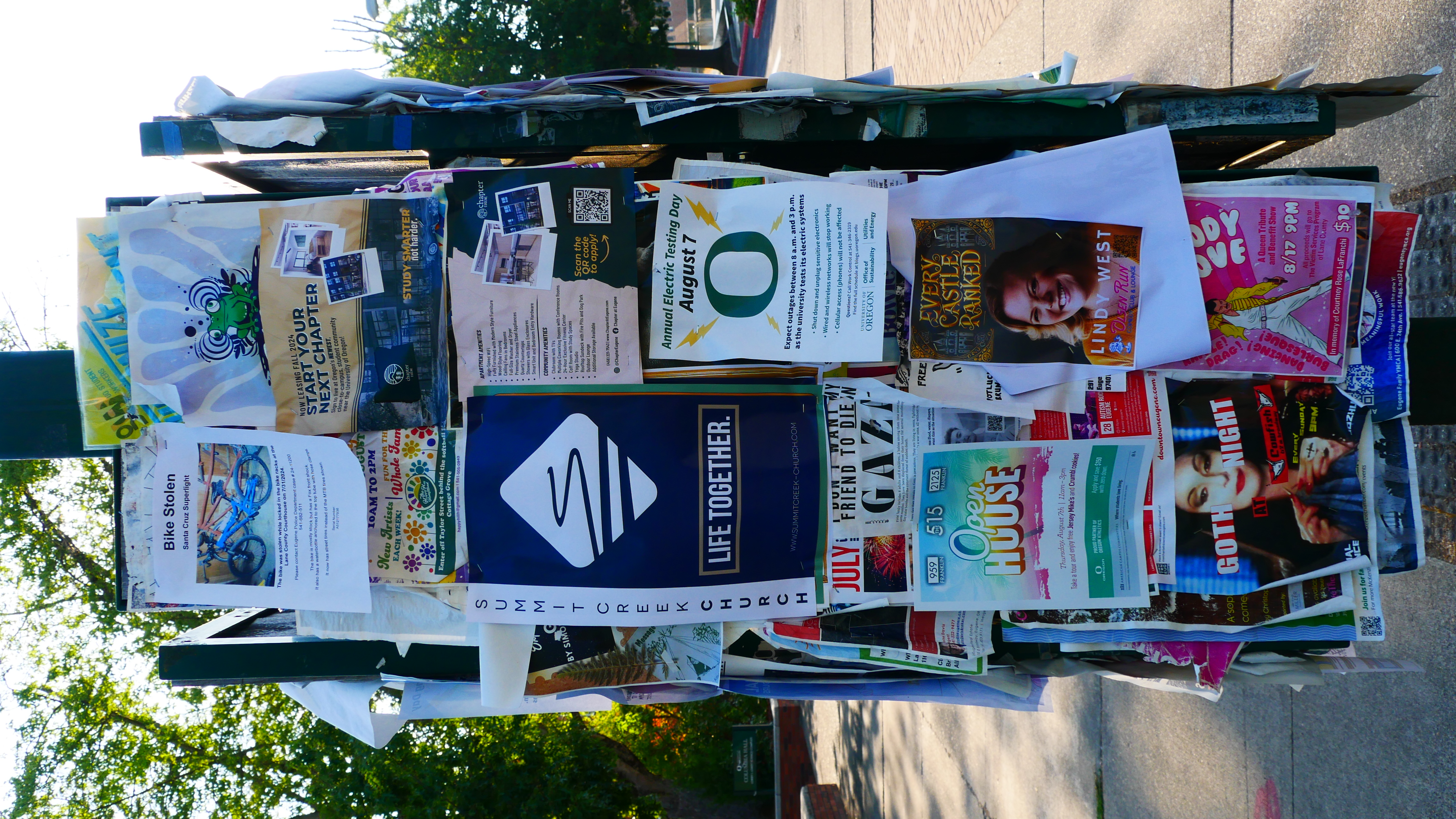 Printed event flyers pinned to a bulletin board.