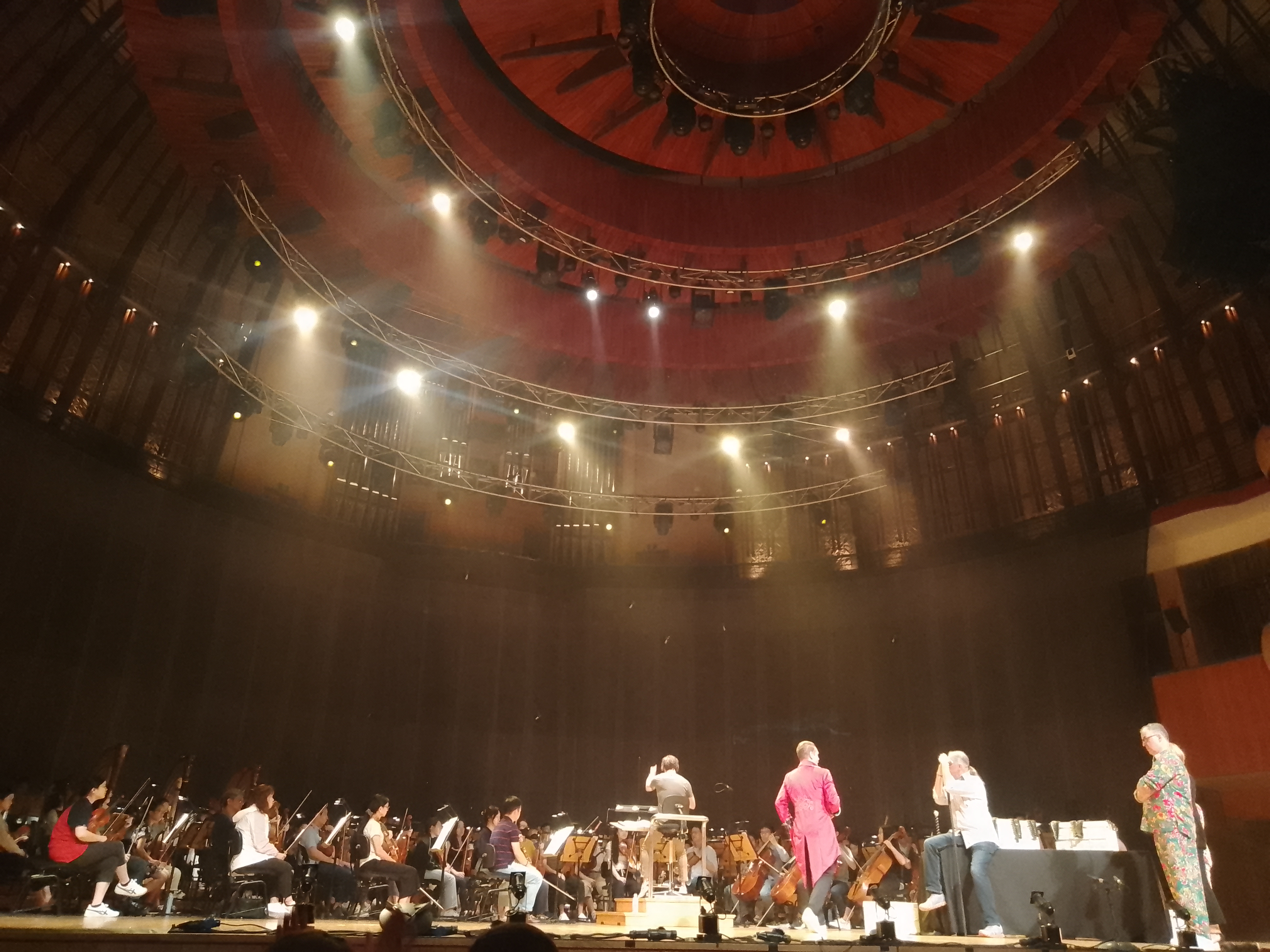 Musicians rehearsing on stage under festival lights.